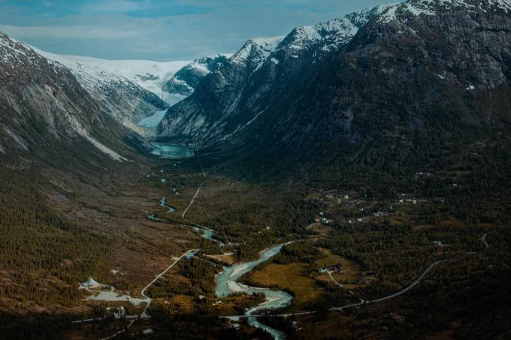 Aerial view down the Jostedalen valley to the Nigardsbreen glacier arm, with the braided glacial river and farms on the valley floor