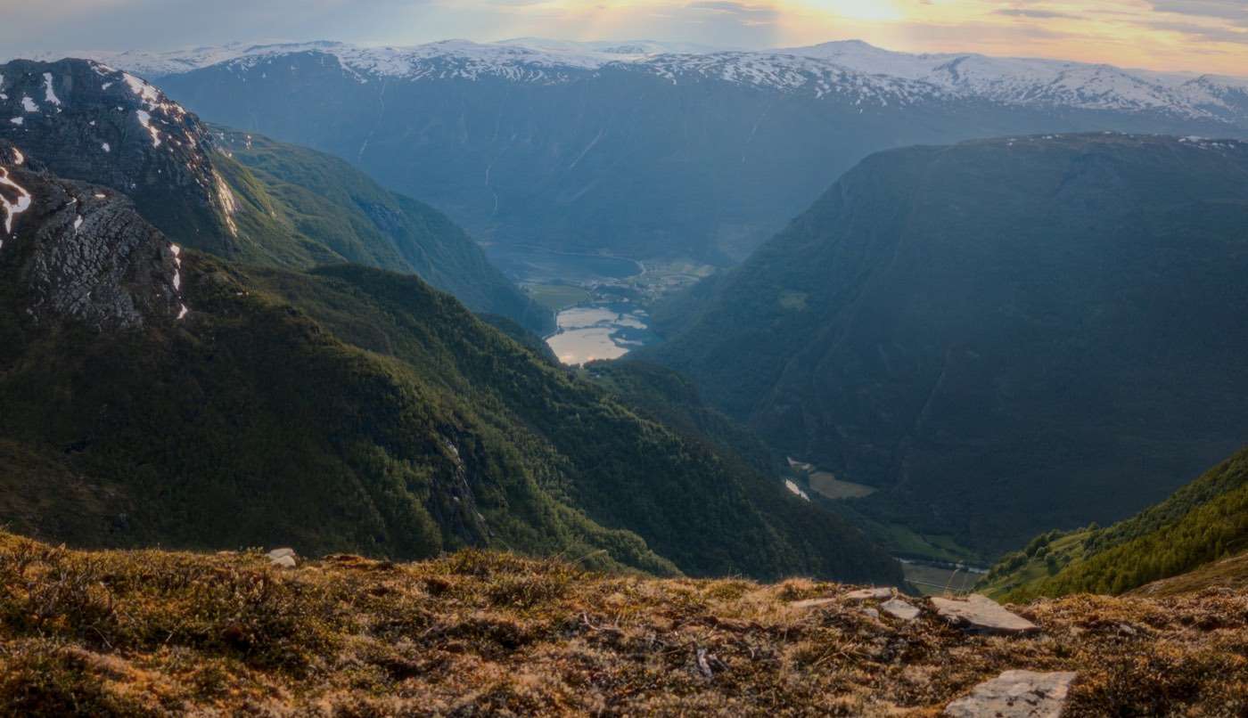 Panorama from a mountain ridge at sunset, looking down to the Skjolden valley, the lake and the innermost arm of the fjord far below
