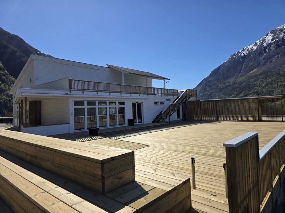 The finished service and market building on the quay with its first-floor balcony, external stair and new timber deck